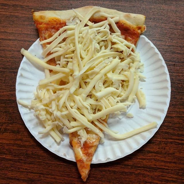 A cold cheese pizza slice from Tino's in Oneonta, New York.&nbsp;