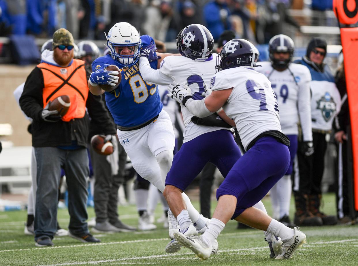 South Dakota State’s Tucker Kraft attempts to stay inbounds while being tackled by Holy Cross defenders in the FCS quarterfinals on Saturday, December 10, 2022, in Sioux Falls.