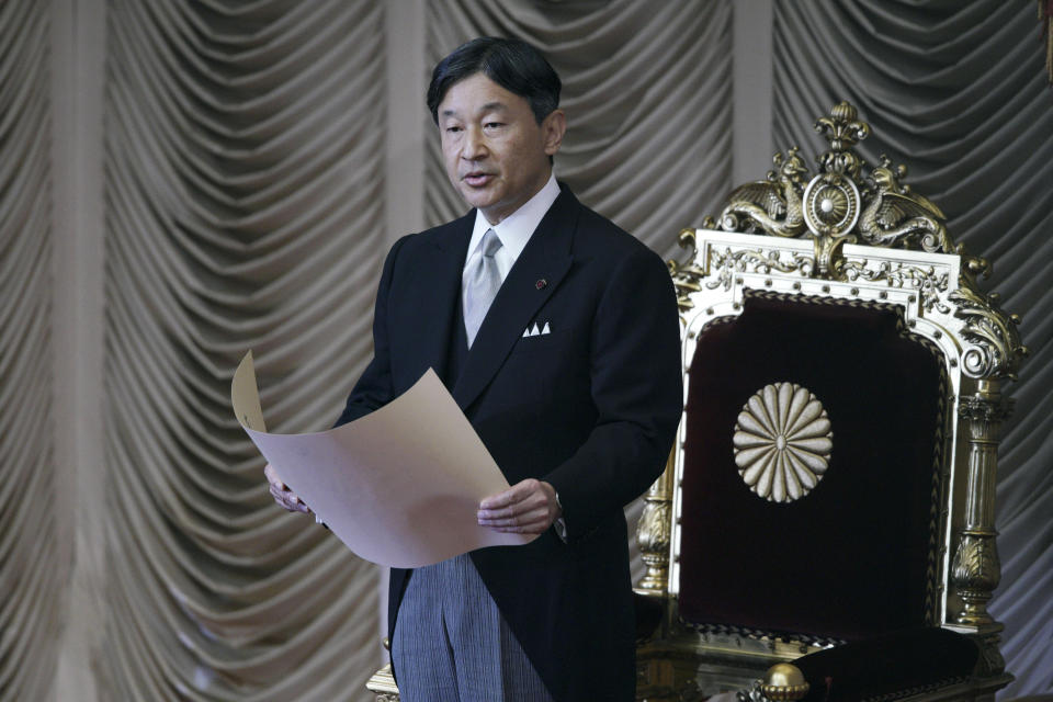 Japan's Emperor Naruhito reads a statement to open formally an extraordinary session at the upper house of parliament in Tokyo Friday, Oct. 4, 2019. (AP Photo/Eugene Hoshiko)