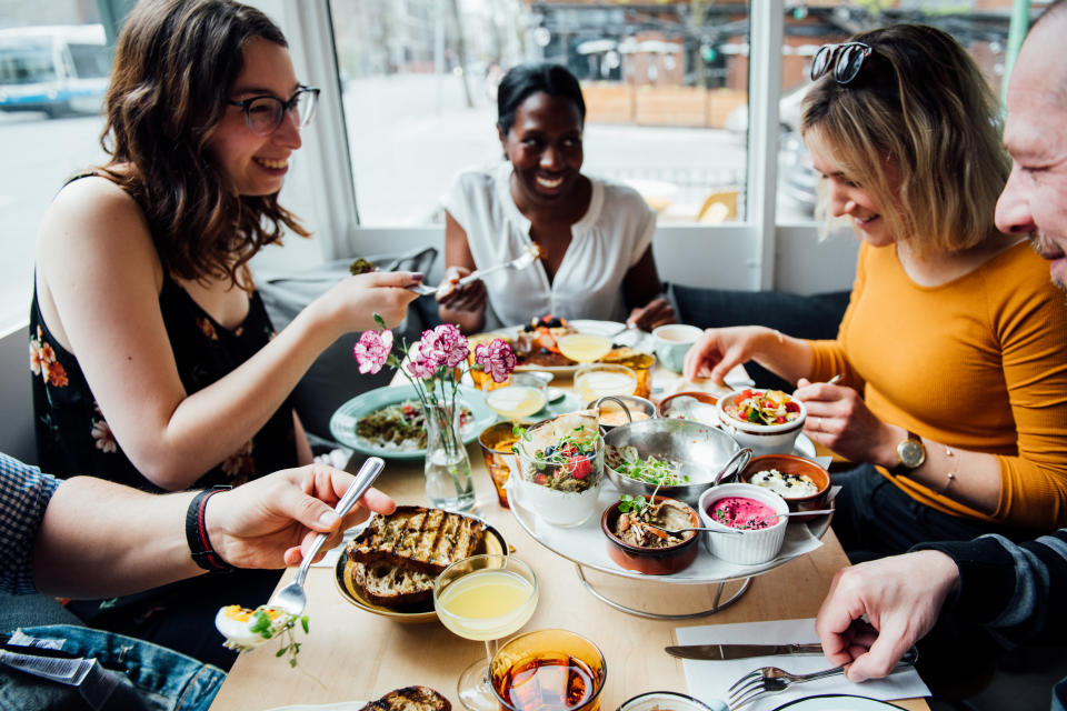 Friends enjoying a meal together at Bloomfield in Montréal