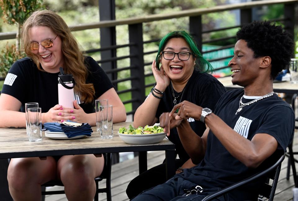 Liz Bowman, left, jokes with other servers Nevy Nouanemany and Keith Josiah during a staff meeting at Noko before the restaurant opened for the evening Wednesday, April 17, 2024, in Nashville, Tenn. Noko’s mission is to take care of its employees with a positive work environment and benefits, which include paid gym memberships, paid vacation and travel stipends.