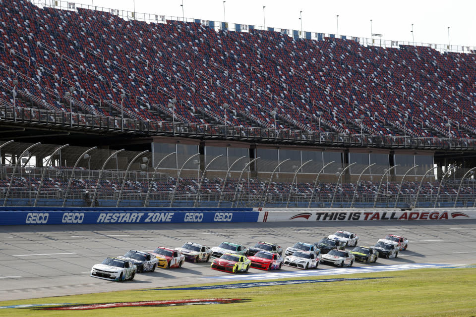 Justin Haley (11) leads the pack in front of empty stands at the start of a NASCAR Xfinity auto race at Talladega Superspeedway in Talladega Ala., Saturday, June 20, 2020. (AP Photo/John Bazemore)