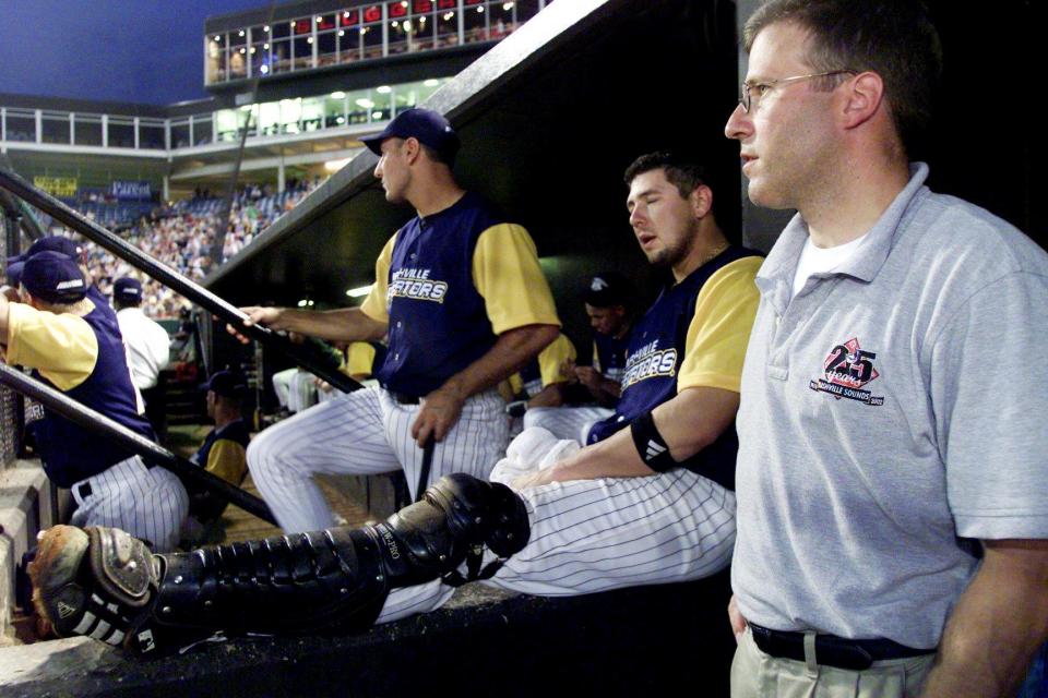 Nashville Sounds General Manager Glenn Yaeger, right, watch his team fall 3-1 to the Memphis Redbirds at Greer Stadium Aug. 22, 2002. Sounds players, in recognition of Nashville Predators Night, are wearing the jerseys with the NHL team logo.