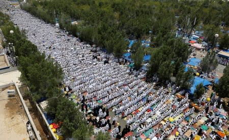 Muslim pilgrims pray outside Namira Mosque on the plains of Arafat during the annual haj pilgrimage, outside the holy city of Mecca