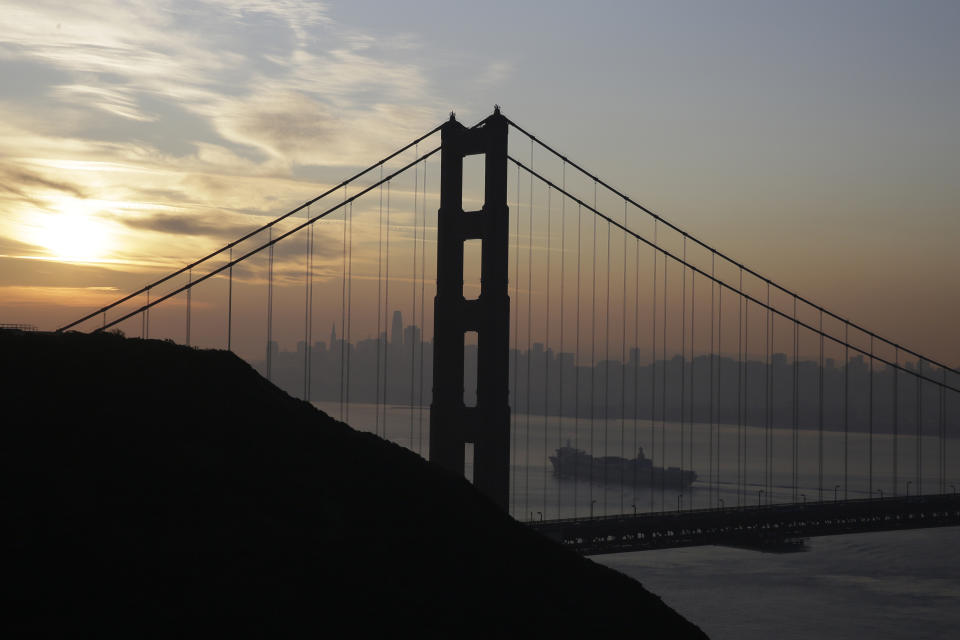 A Matson container ship passes the Golden Gate Bridge Monday, Oct. 28, 2019, in Sausalito, Calif., as smoke from wildfires blankets the San Francisco skyline in the background. A wildfire that has been burning in Northern California's wine country since last week grew overnight as nearly 200,000 people remain under evacuation orders. (AP Photo/Eric Risberg)