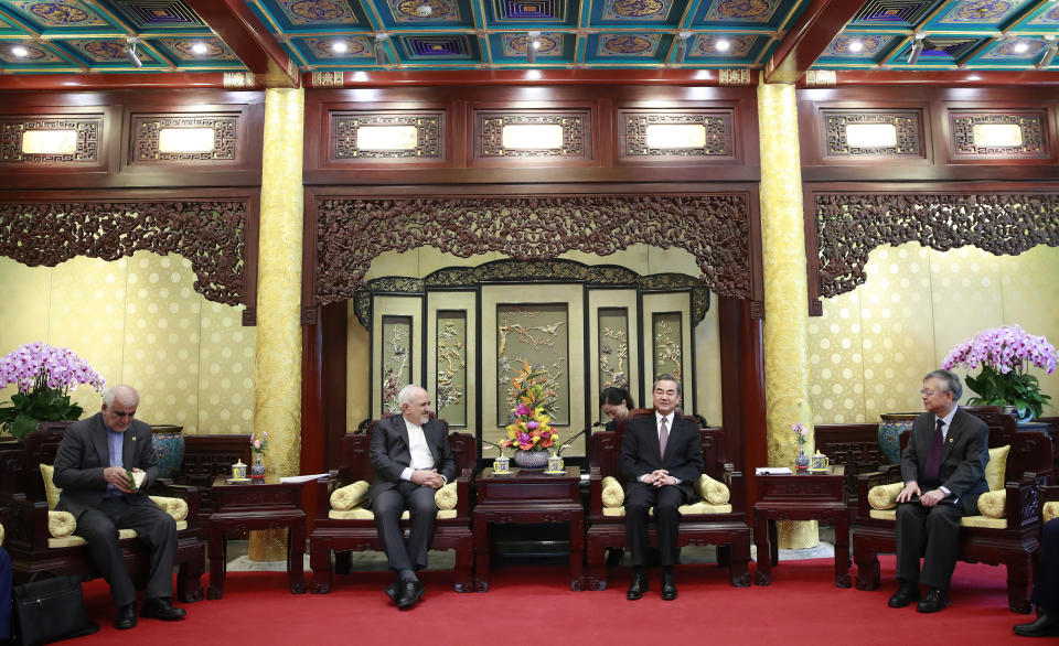 Iranian Foreign Minister Mohammad Javad Zarif, center left, and his Chinese counterpart Wang Yi, center right, during their meeting at the Diaoyutai State Guesthouse in Beijing, China, Tuesday, Feb. 19, 2019. The foreign ministers of China and Iran met in Beijing on Tuesday amid efforts to preserve the 2015 nuclear deal with Tehran.(How Hwee Young/Pool Photo via AP)