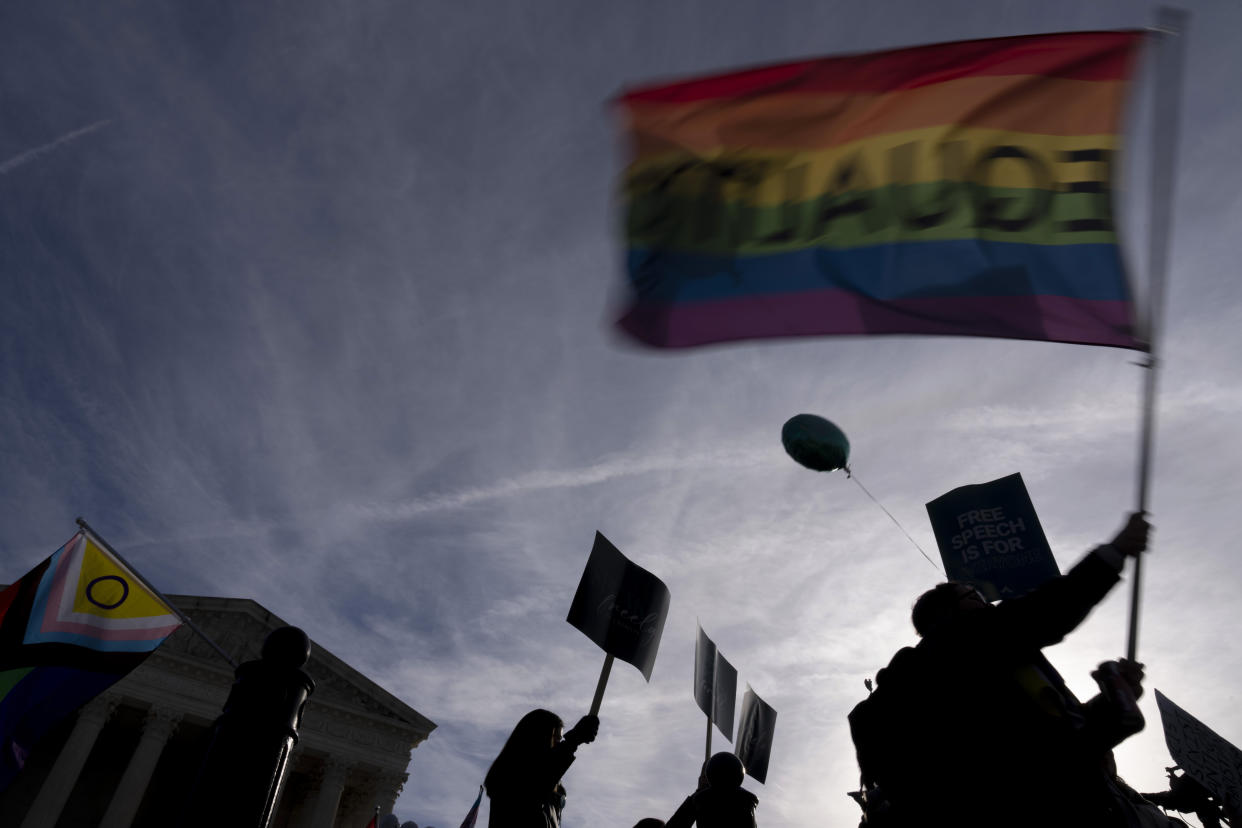 FILE - People on both sides of the debate rally outside the Supreme Court in Washington, Monday, Dec. 5, 2022. In a defeat for gay rights, the Supreme Court's conservative majority ruled Friday, June 30, 2023, Lorie Smith, a Christian graphic artist and website designer in Colorado, who wants to design wedding websites can refuse to work with same-sex couples. (AP Photo/Andrew Harnik)