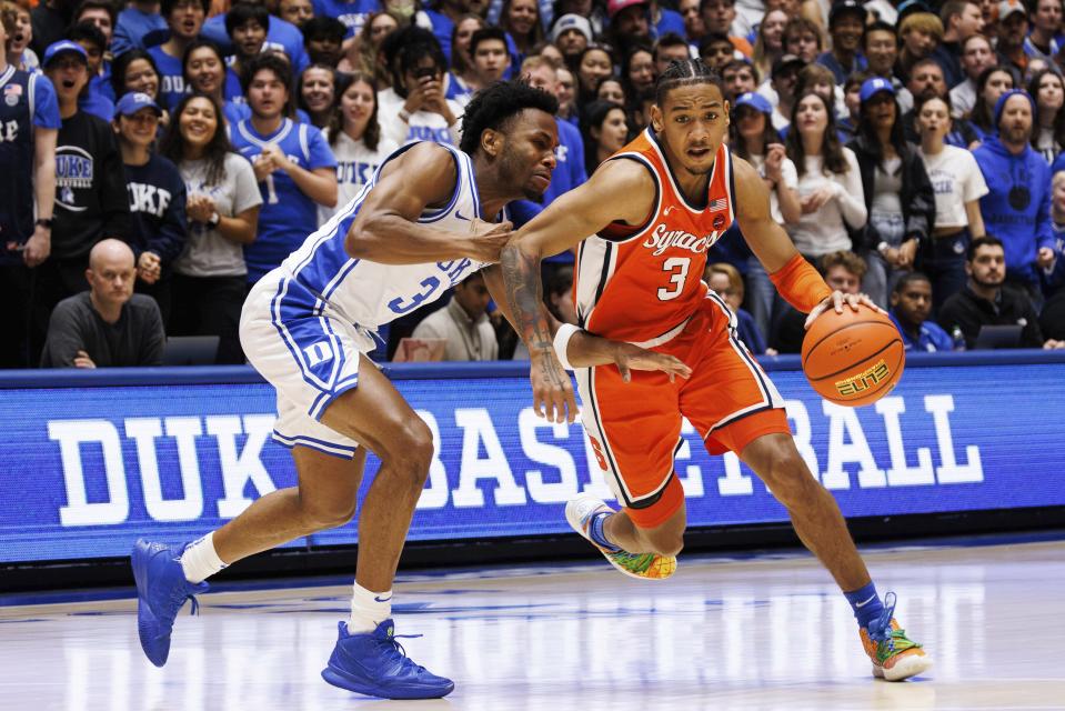 Syracuse's Judah Mintz, right, handles the ball as Duke's Jeremy Roach, left, defends during the first half of an NCAA college basketball game in Durham, N.C., Tuesday, Jan. 2, 2024. (AP Photo/Ben McKeown)