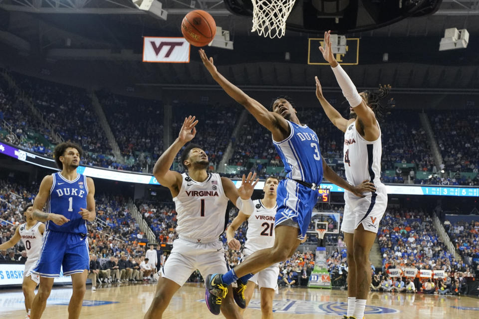 Duke guard Jeremy Roach (3) drives between Virginia forward Jayden Gardner (1) and guard Armaan Franklin (4) during the second half of an NCAA college basketball game for the championship of the Atlantic Coast Conference Tournament in Greensboro, N.C., Saturday, March 11, 2023. (AP Photo/Chuck Burton)