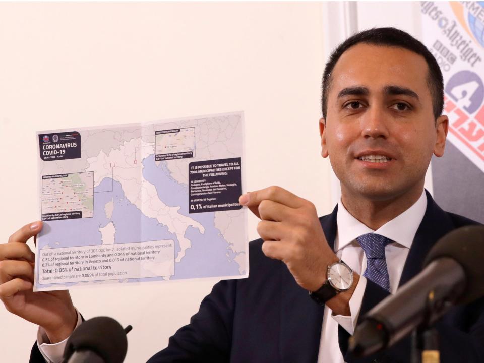 Italian Foreign Minister Luigi di Maio holds up a map of Italy showing the municipalities in regions of Lombardy and Veneto where it is not possible to travel, during a press conference at the foreign press association, in Rome, Thursday, Feb. 27, 2020. The government is seeking to calm fears about the outbreak, which has seen countries issue travel advisories warning their citizens to avoid visiting hard-hit Lombardy and Veneto regions, which have seen the most cases.  (AP Photo/Alessandra Tarantino)