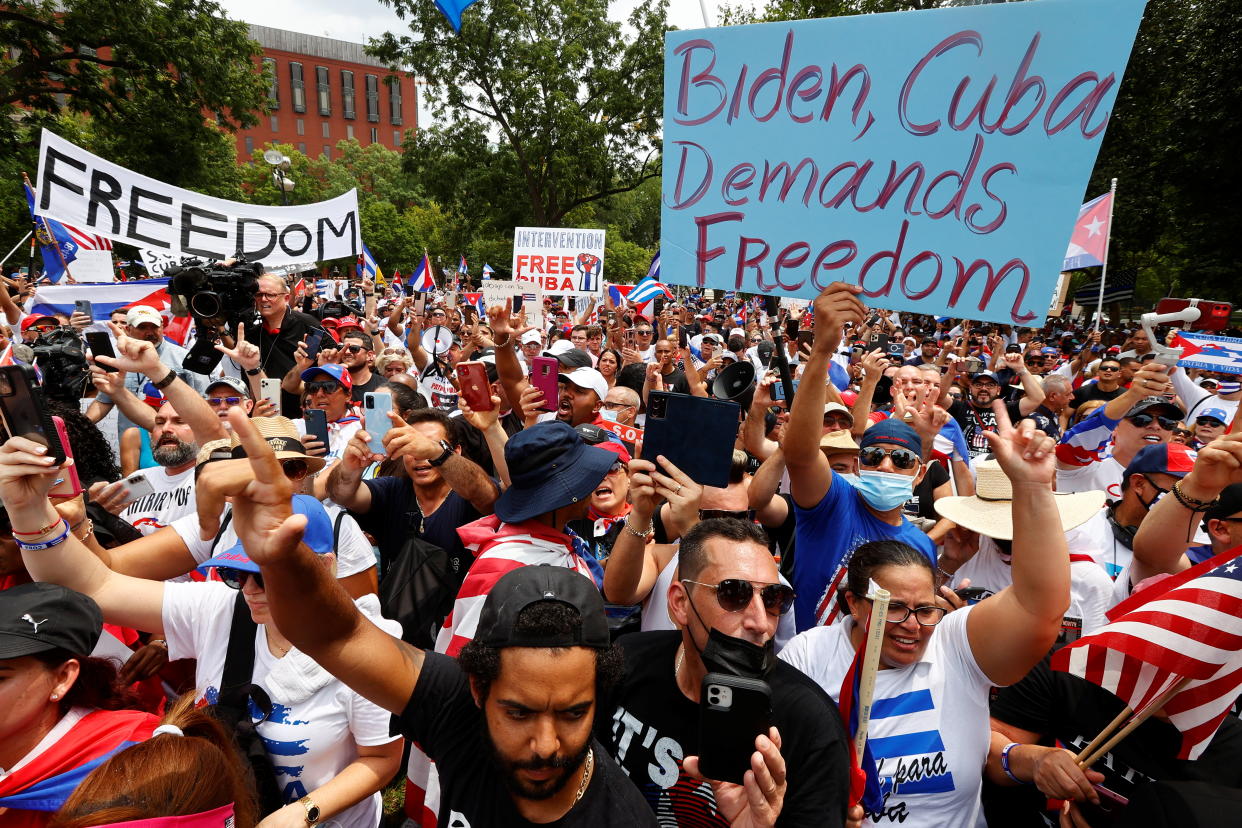 Cuban-American demonstrators hold signs reading: Biden, Cuba demands freedom and Free Cuba.