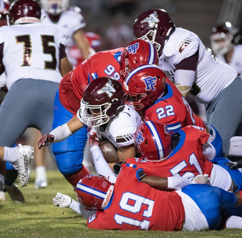 Deangelo Shorts (10) is taken down by a host of Eagles during the Niceville vs Pine Forest football game at Pine Forest High School in Pensacola on Friday, Oct. 7, 2022.