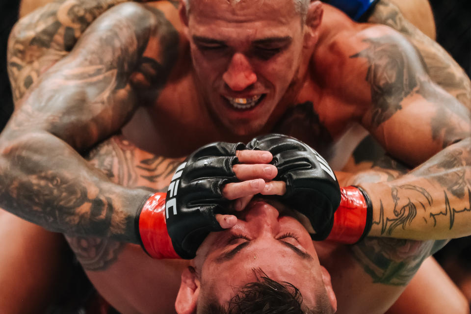 LAS VEGAS, NEVADA - DECEMBER 11: Charles Oliveira (top) of Brazil grapples with Dustin Poirier in their lightweight title fight during the UFC 269 event at T-Mobile Arena on December 11, 2021 in Las Vegas, Nevada. (Photo by Carmen Mandato/Getty Images)