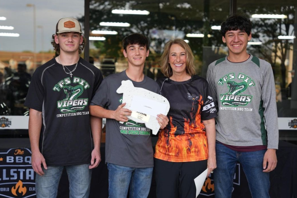 Pitmaster and World Junior BBQ League founder Melissa Cookston poses with the 2022 World Junior BBQ League Championship winning team Pit Vipers