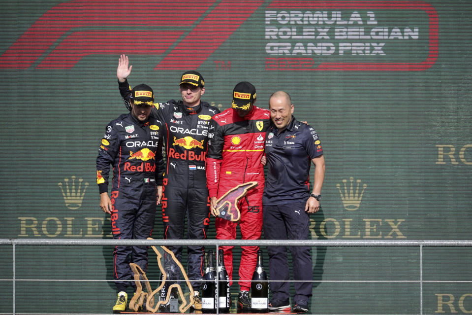 First place Red Bull driver Max Verstappen of the Netherlands, second left, celebrates on the podium with second place Red Bull driver Sergio Perez of Mexico, left, and third place Ferrari driver Carlos Sainz of Spain, second right, during the Formula One Grand Prix at the Spa-Francorchamps racetrack in Spa, Belgium, Sunday, Aug. 28, 2022. (AP Photo/Olivier Matthys)