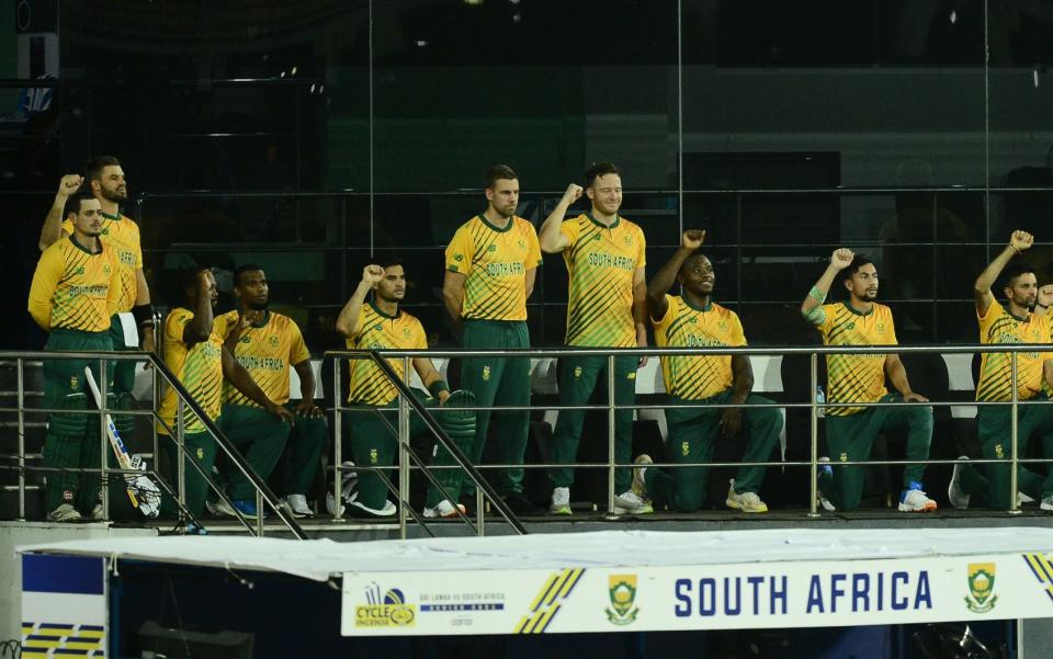 De Kock, pictured far left during a game in September, said being called a racist for not taking the knee had hurt his family - GETTY IMAGES