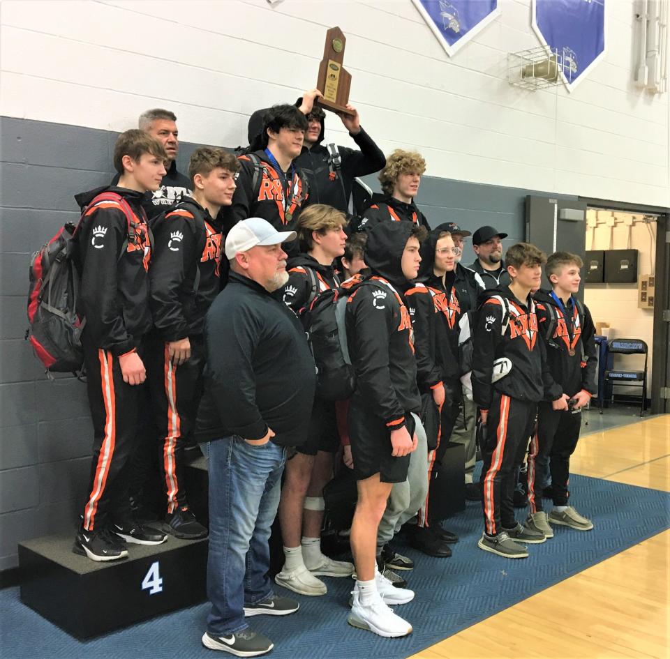 Ryle celebrates with its team championship trophy at the KHSAA Region 5 wrestling tournament, Feb. 11, 2023, at Walton-Verona High School.