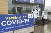 A man is screened before entering a COVID-19 vaccination clinic in Montreal, Wednesday, April 21, 2021. (Paul Chiasson/The Canadian Press via AP)