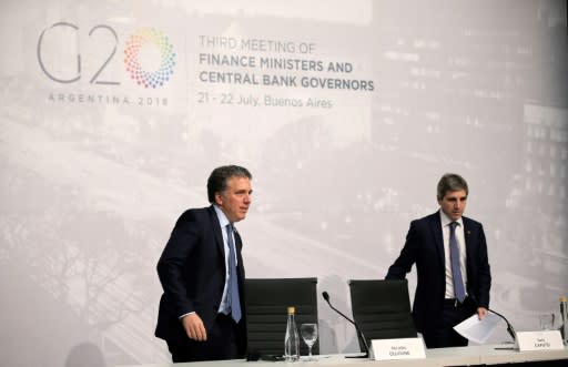 Argentina's Economy Minister Nicolas Dujovne (L), with Central Bank President Luis Caputo, said the group must focus on harmony even amid rising trade tensions