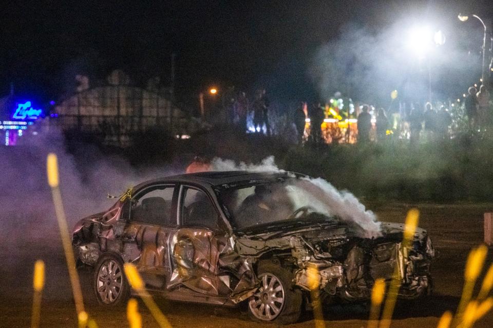 Spectators gather to watch a demolition derby during the Granite State Fair on Sunday, Sept. 19, 2021.