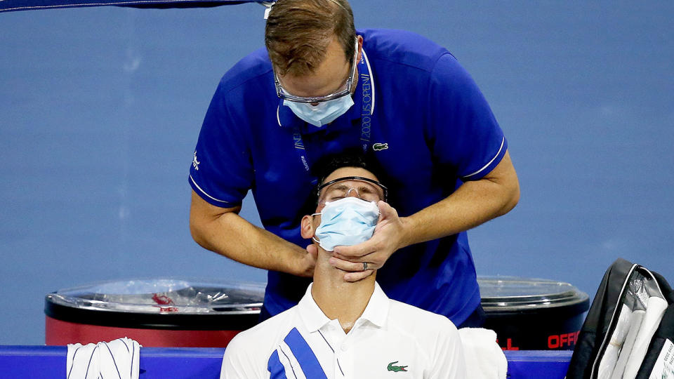 Djokovic is seen in this picture being treated for a neck complaint.