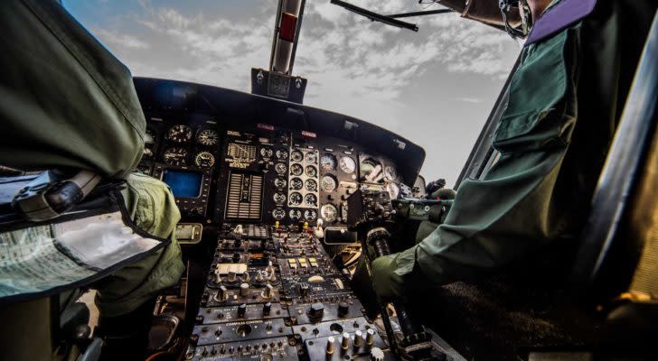 the cockpit of a plane with two pilots sitting in it