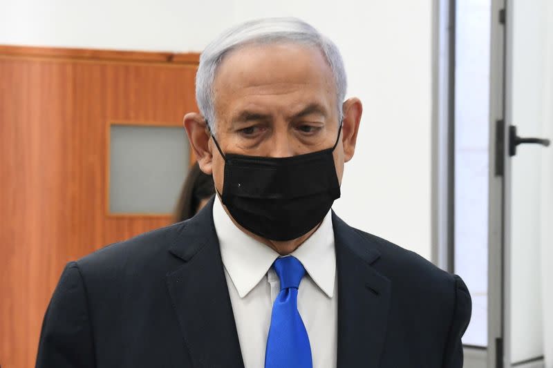 Israeli Prime Minister Benjamin Netanyahu looks on as he arrives to a hearing in his corruption trial at Jerusalem's District Court