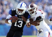 Jalen Whitlow #13 of the Kentucky Wildcats runs with the ball while defended by Corey Broomfield #25 of the Mississippi State Bulldogs during the SEC game at Commonwealth Stadium on October 6, 2012 in Lexington, Kentucky. (Photo by Andy Lyons/Getty Images)