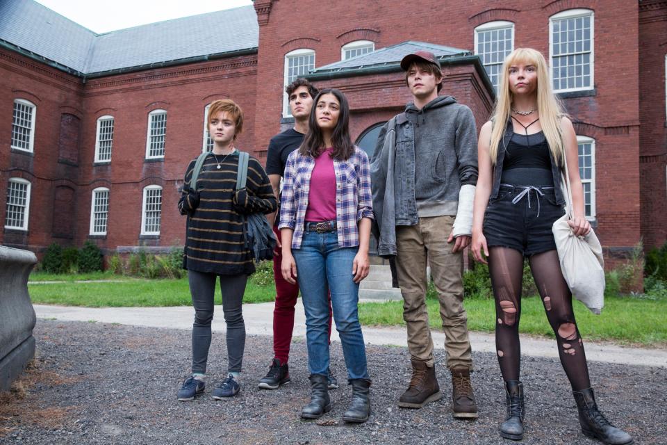 Maisie Williams, Henry Zaga, Blu Hunt, Charlie Heaton, and Anya Taylor-Joy stand outside a brick building