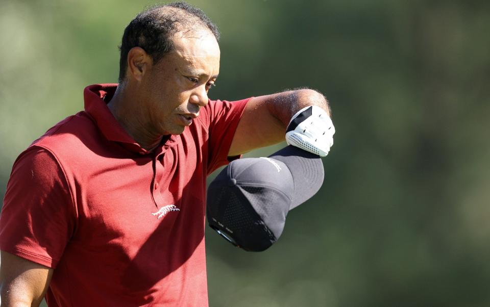 Tiger Woods takes his cap off on the fifth hole