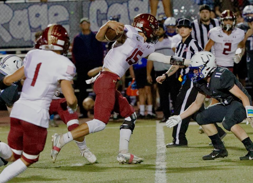 West Valley quarterback Noah Mason (15) gains yards against U-Prep on Oct. 21.