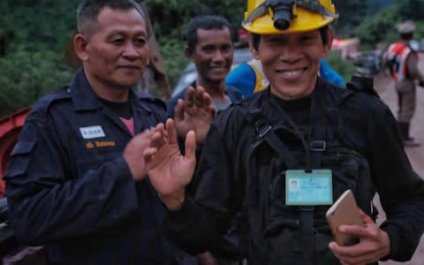 Rescue workers along the main road leading to Tham Luang Nang Non cave  - Credit: Linh Pham/Getty Images