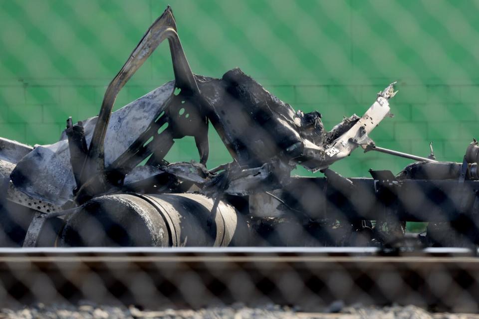 Charred remains of a truck that exploded, injuring several firefighters, at