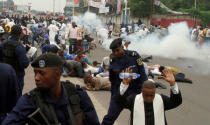 Riot policemen fire tear gas to disperse Catholic priest and demonstrators during a protest against President Joseph Kabila, organized by the Catholic church in Kinshasa, Democratic Republic of Congo January 21, 2018. REUTERS/Kenny Katombe