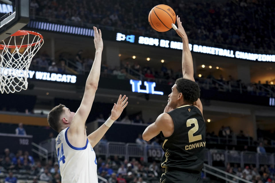 Oakland's Chris Conway (2) shoots over Kentucky's Zvonimir Ivisic (44) during the first half of a college basketball game in the first round of the men's NCAA Tournament on Thursday, March 21, 2024, in Pittsburgh. (AP Photo/Matt Freed)