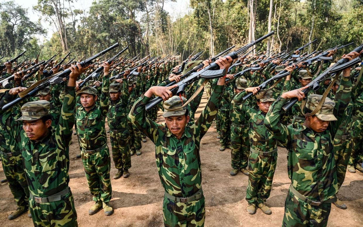 Members of the ethnic rebel group Ta'ang National Liberation Army (TNLA) at their base camp in the forest in Myanmar's northern Shan State.