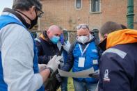 Volunteers distribute protective face masks to the people to contain the spread of the coronavirus disease (COVID-19)