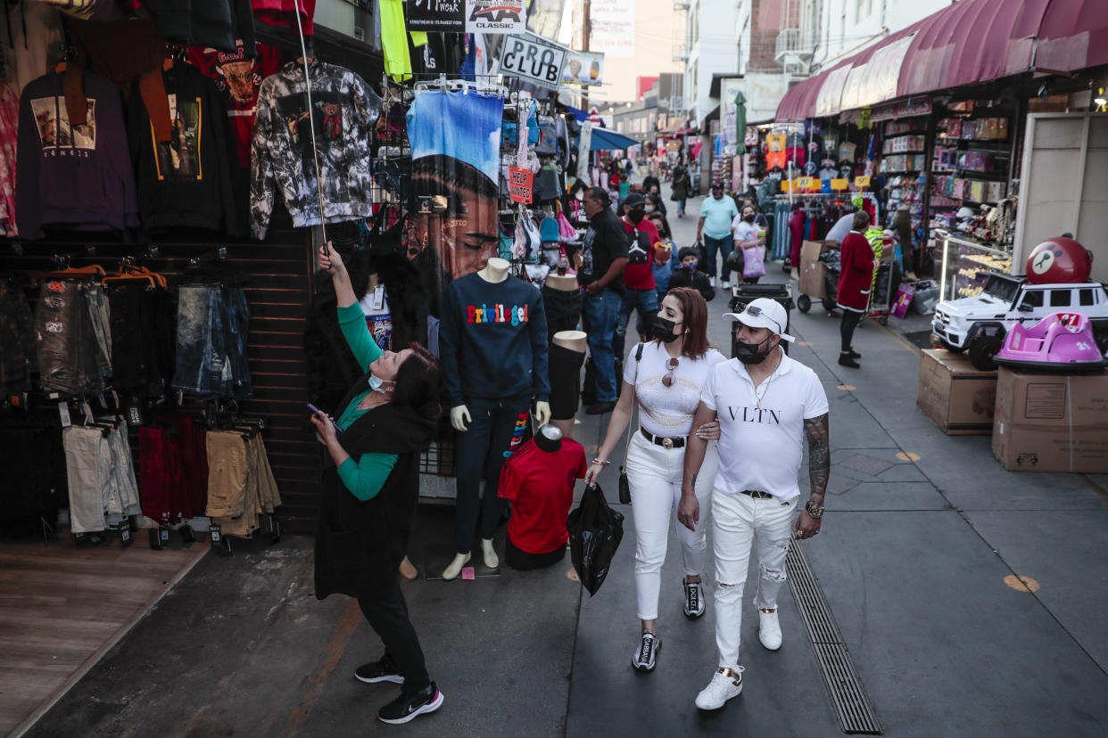 Los Angeles, CA, Friday, February 19, 2021 - Shoppers walk along Santee Alley late in the afternoon downtown.  (Robert Gauthier/Los Angeles Times via Getty Images)