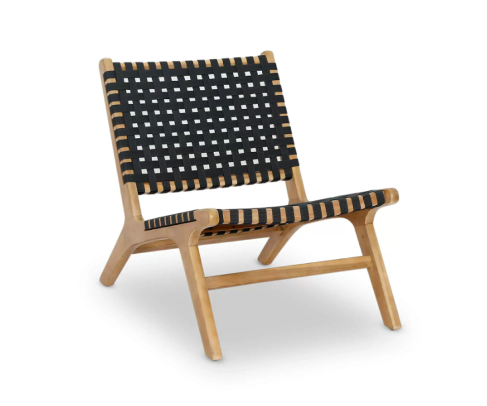 The low-rise Havana Outdoor Armchair in black woven fabric in a tan wooden frame against a white background.