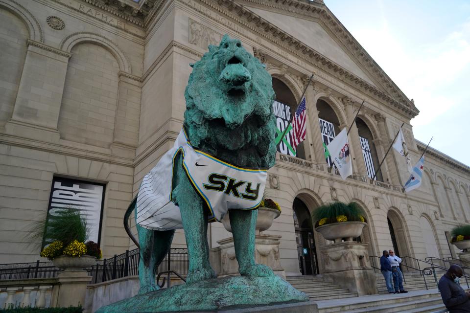 A lion statue outside the Art Institute of Chicago wears a Chicago Sky jersey as the city celebrates the team's 2021 WNBA championship.