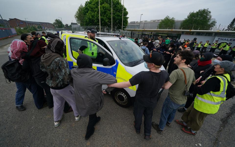 Pro-Palestine campaigners surround a police vehicle