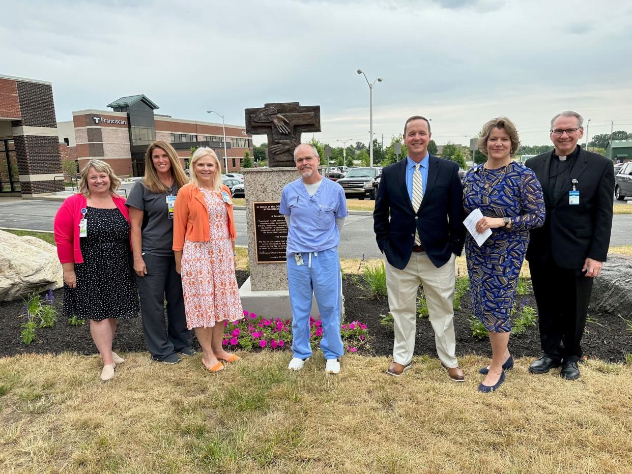 From left, Julie Lavender, ICU nursing manager, Tara Wilson, clinical coordinator for respiratory therapy, Lori Warner, director of patient care services, Daniel Gay, DO, hospitalist with Franciscan Physician Network IMPACT Center, Eric Wise, vice president, Central Indiana Tonn and Blank Construction, Trish Weber, CEO of Franciscan Health Mooresville and Carmel, and Fr. James Barrand.