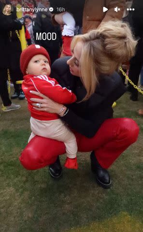 <p>Brittany Mahomes/Instagram</p> Bronze sits on Brittany's lap on the sidelines