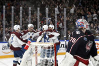 Colorado Avalanche players celebrate the opening goal by Artturi Lehkonen behind Columbus Blue Jackets' goalkeeper Joonas Korpisalo, right, during the 2022 NHL Global Series ice hockey match between Colorado Avalanche and Columbus Blue Jackets in Tampere, Finland, Saturday, Nov. 5, 2022. (Emmi Korhonen./Lehtikuva via AP)