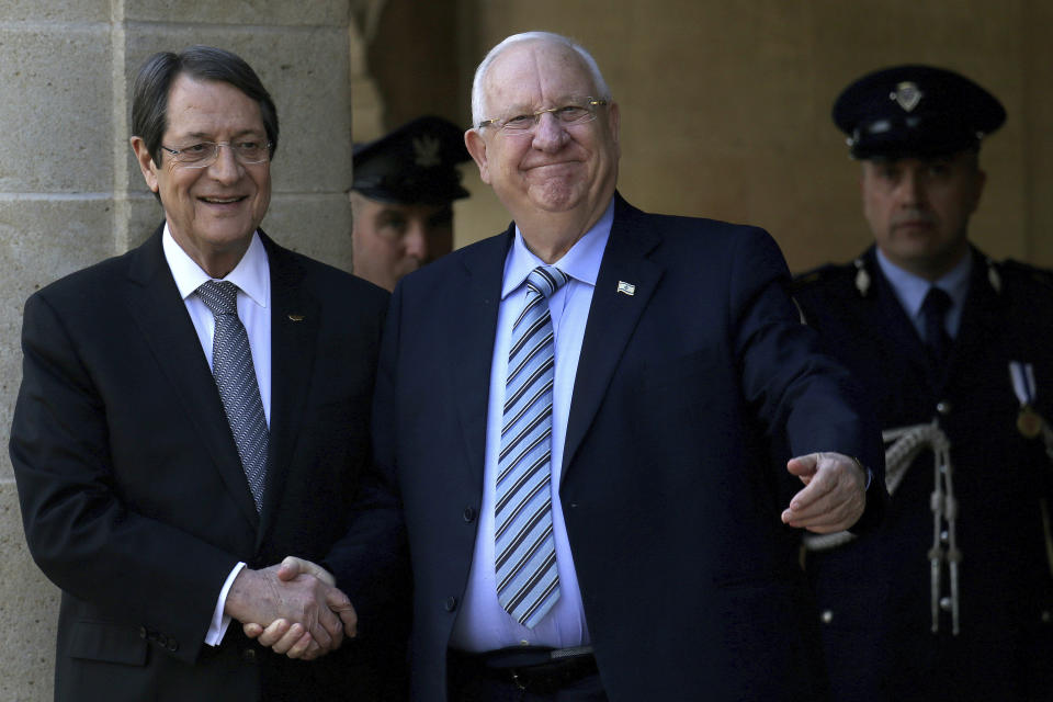 Cyprus' president Nicos Anastasiades, left, and Israel's President Reuven Rivlin, shake hands during a welcoming ceremony at the presidential palace in divided capital Nicosia, Cyprus, on Tuesday, Feb. 12, 2019. Rivlin is in Cyprus for a one-day official visit for talks. (AP Photo/Petros Karadjias)