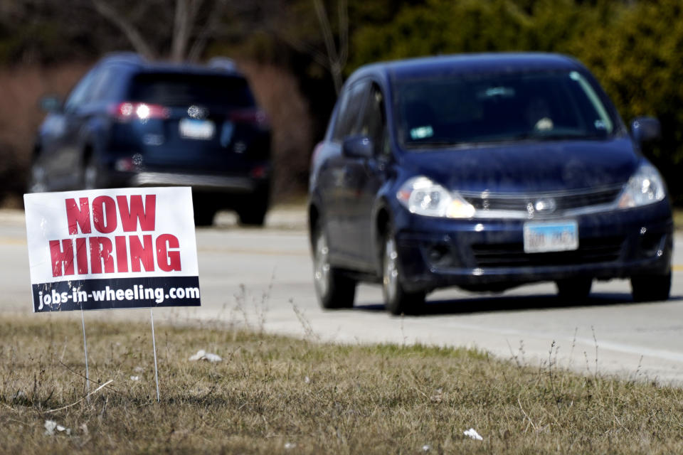 A hiring sign shows in Wheeling, Ill., Sunday, March 21, 2021. America’s employers unleashed a burst of hiring in March, adding 916,000 jobs in a sign that a sustained recovery from the pandemic recession is taking hold as vaccinations accelerate, stimulus checks flow through the economy and businesses increasingly reopen. (AP Photo/Nam Y. Huh)