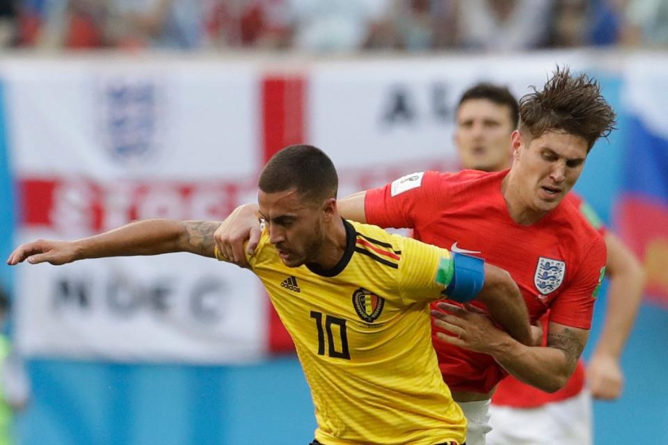 Close encounter: Eden Hazard holds off John Stones during the third place play-off: AP