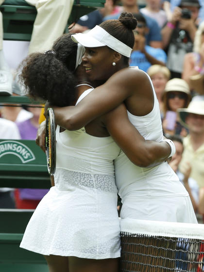 Serena Williams hugs her sister Venus after winning their singles match. (AP)