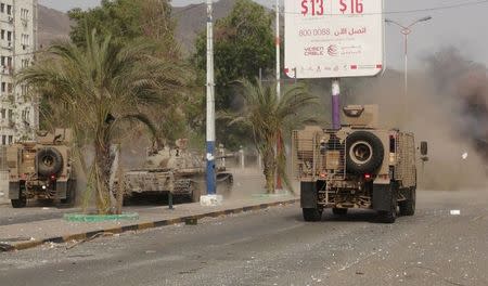 Military vehicles of the Southern Resistance fighters move during clashes with Houthi fighters on a street in Yemen's southern port city of Aden July 17, 2015. REUTERS/Stringer