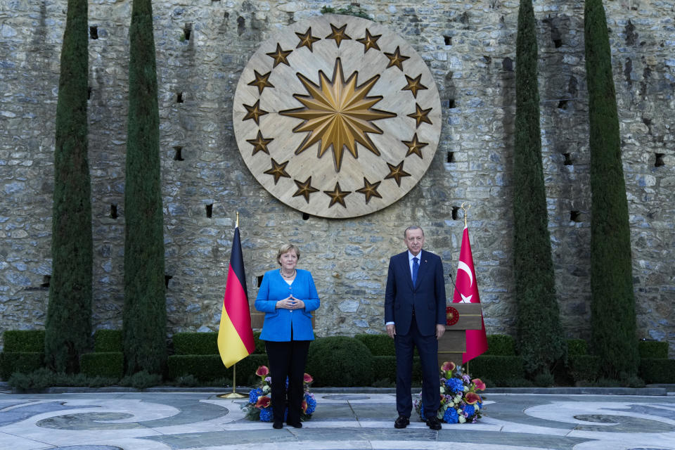 Turkey's President Recep Tayyip Erdogan, right, and German Chancellor Angela Merkel pose for the media at the end of a joint news conference following their meeting at Huber vila, Erdogan's presidential resident, in Istanbul, Turkey, Saturday, Oct. 16, 2021. The leaders discussed Ankara's relationship with Germany and the European Union as well as regional issues including Syria and Afghanistan. (AP Photo/Francisco Seco)
